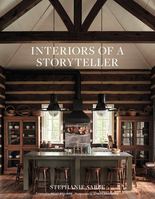 Book cover of 'Interiors of a Storyteller' with a rustic kitchen interior.