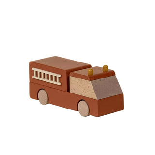Wooden toy fire truck on a beige background