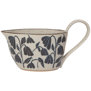 Ceramic mug with floral design on a white background