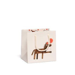 Gift bag with a dog holding a red balloon design on a white background