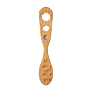 Wooden tool with holes on a marble surface