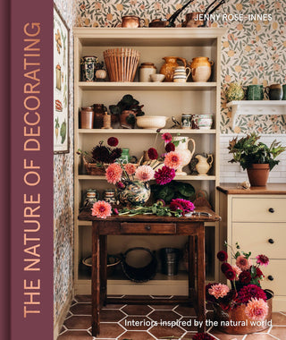 Book cover of 'The Nature of Decorating' by Jenny Rose Innes, featuring a decorated interior with shelves and flowers.