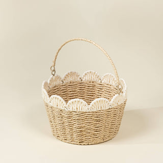 Woven basket with scalloped edge on a beige background
