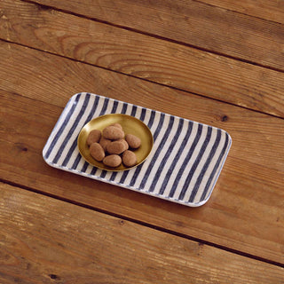 Rectangular tray with striped pattern on a wooden surface