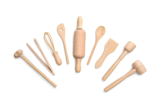 Set of wooden kitchen utensils including a rolling pin, spoons, and whisks on a white background