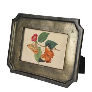 Decorative metal frame with a butterfly and flower design on a white background