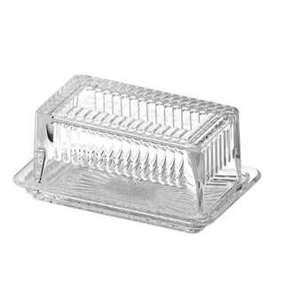 Clear glass butter dish on a white background