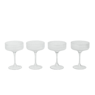 Four white textured cocktail glasses on a white background