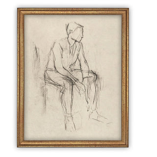 A framed black and white sketch of a man seated, displayed in a gold frame.