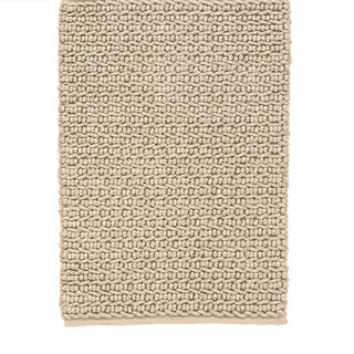 Beige textured rug on a white background