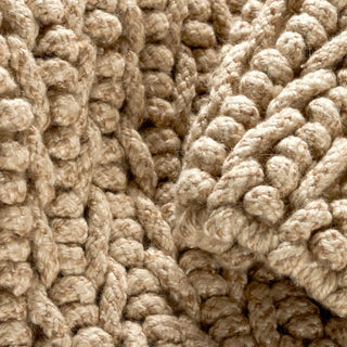 Close-up of textured beige fabric with a knitted pattern