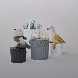 Children's toys and baskets on a light gray background