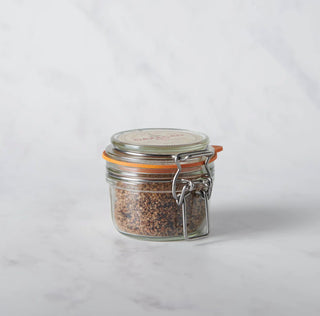 Glass jar with a metal clasp lid on a white background