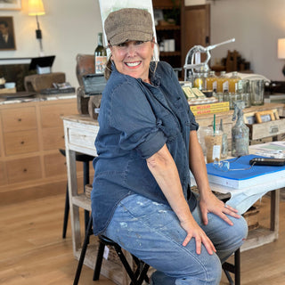 Person sitting on a chair in a workshop or studio setting