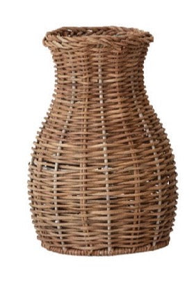 A natural brown woven wicker basket vase with a flared rim and textured vertical weave, shown against a plain white background.