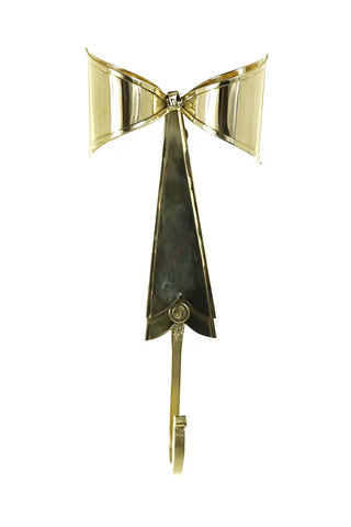 Decorative gold bow with a hook on a white background