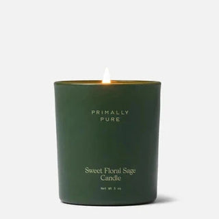 Green candle with 'Primally Pure' branding on a white background