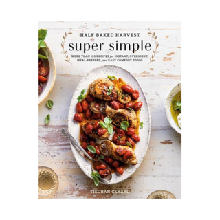 Cookbook cover of 'Half Baked Harvest Super Simple' with a dish of food on a wooden surface.