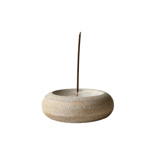 Ceramic incense holder with a single incense stick on a white background