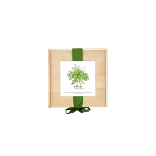 Wooden box with a green ribbon and a card on a white background