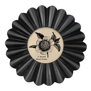 Black round photo frame with floral design on a white background