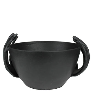 Black bowl with handle-like extensions on a white background