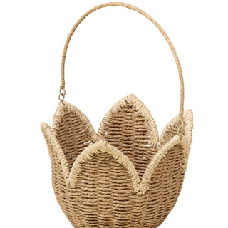 Woven basket with a handle on a beige background