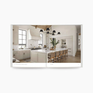 Modern kitchen with white cabinets, island, and pendant lights.