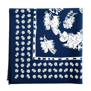 Navy blue bandana with white floral patterns on a beige background