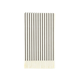 A set of white fringed paper napkins with a black ticking pattern laid out in a fan-like arrangement.