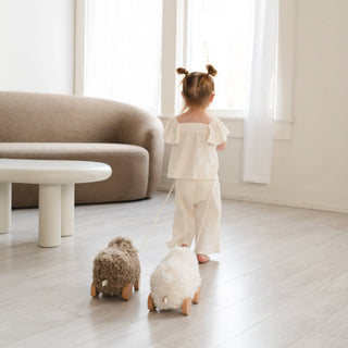 Child playing with plush toys in a minimalistic room