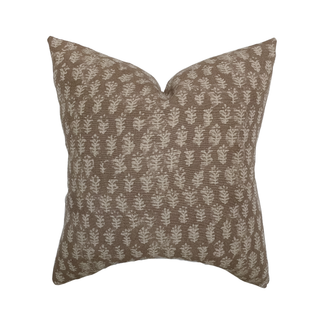 Decorative pillow with leaf pattern on a white background