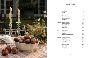 Table setting with apples and candles next to a menu or table of contents page.