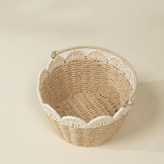 Woven basket with decorative trim on a beige background