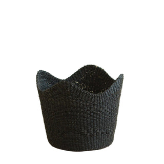Black woven basket on a beige background