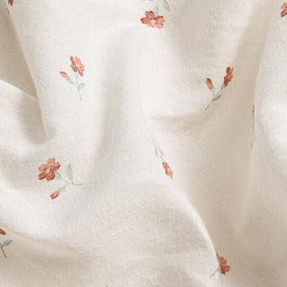Close-up of white fabric with small floral patterns