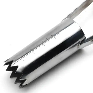 Metallic kitchen tool with a zigzag edge on a white background