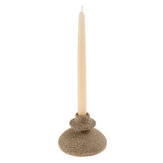Decorative candle holder with a beige candle on a white background