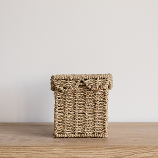 Woven basket on a wooden surface with a plain background