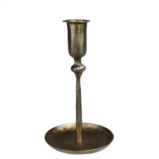 A medium-sized, fluted metal candleholder with a brass finish and a wide bottom plate.