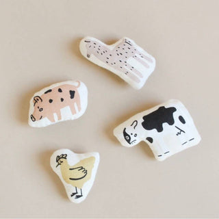 Four animal-shaped ceramic tiles on a beige background