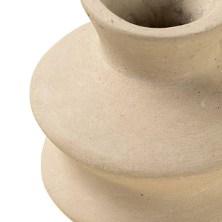 Close-up of a beige ceramic vase on a beige background