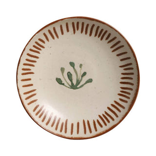 Ceramic plate with decorative brown rim and green leaf design on a white background