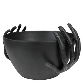 Black bowl with claw-like handles on a white background