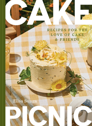 Book cover of 'Picnic Cake' with a cake on a table, featuring Elisa Sunga.