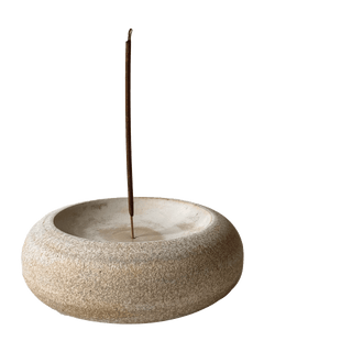 Stone incense burner with a single incense stick on a transparent background