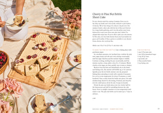 Cherry and Pine Nut Brittle Sheet Cake on a picnic blanket with flowers and people eating.
