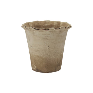 Brown ceramic planter with wavy rim on a white background
