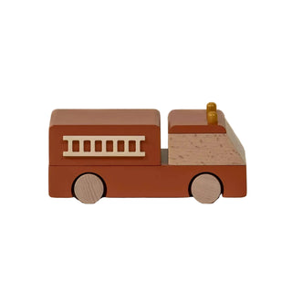 Wooden toy fire truck on a beige background
