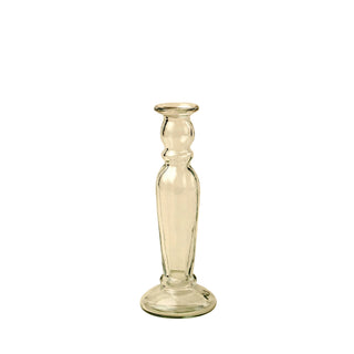 Clear glass candlestick on a beige background